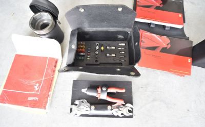 Photo of a Ferrari Enzo Owner's Manual, Ferrari Knock Off Wheel Center LUG Socket, Ferra Ferrari Enzo Owner's Manual, Ferrari Knock Off Wheel Center LUG Socket, Ferrari Enzo Tool Kit, Ferrari Scarf for sale